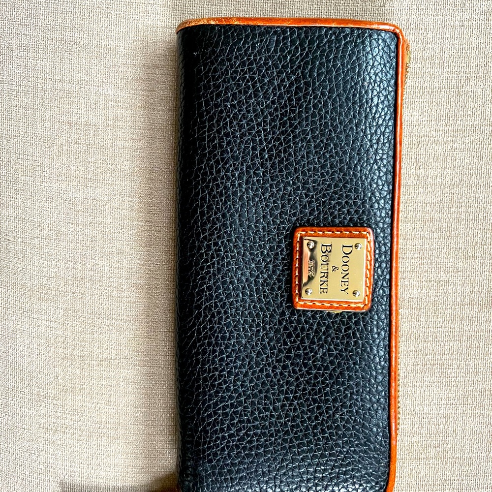 Dooney and Bourke black leather wallet with brown leather trim and red interior